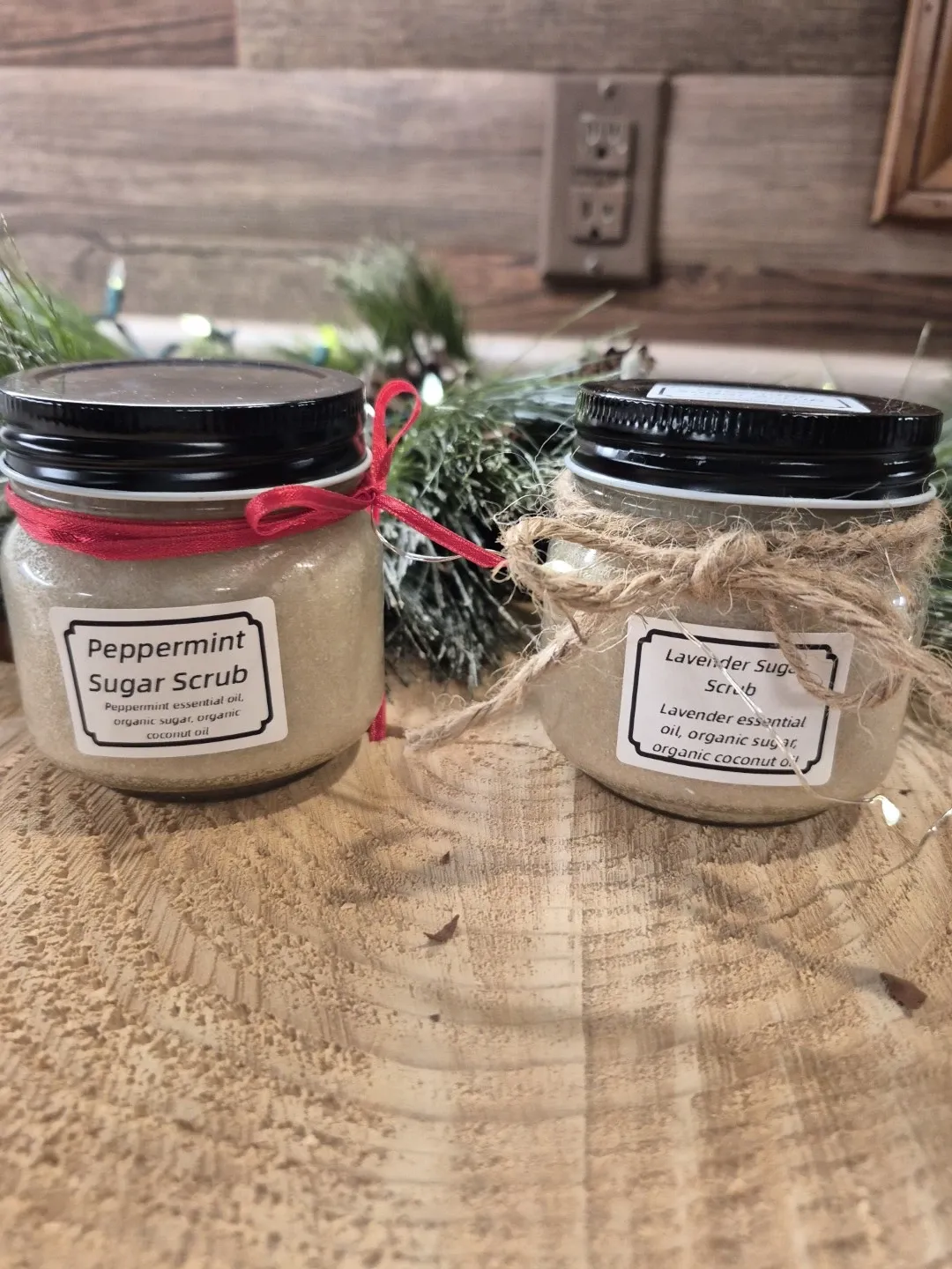 Two small glass bottles of sugar scrub.