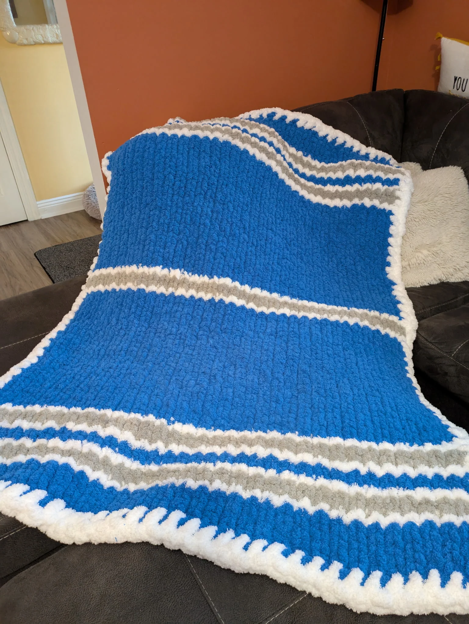 A finger-knit blanket in Lions colors.